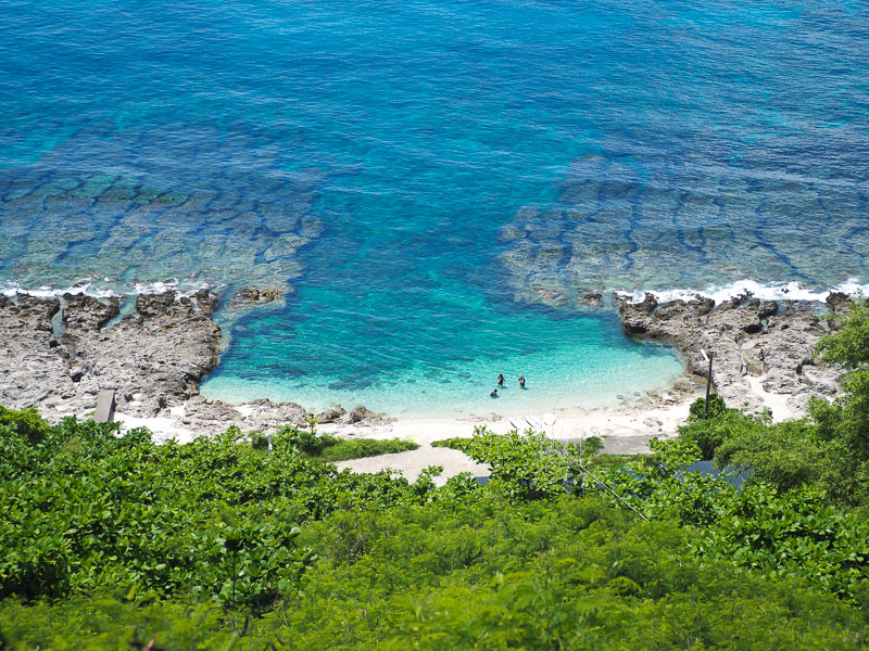 Secret Beach on Xiaoliuqiu, shot from above, with three people in the water