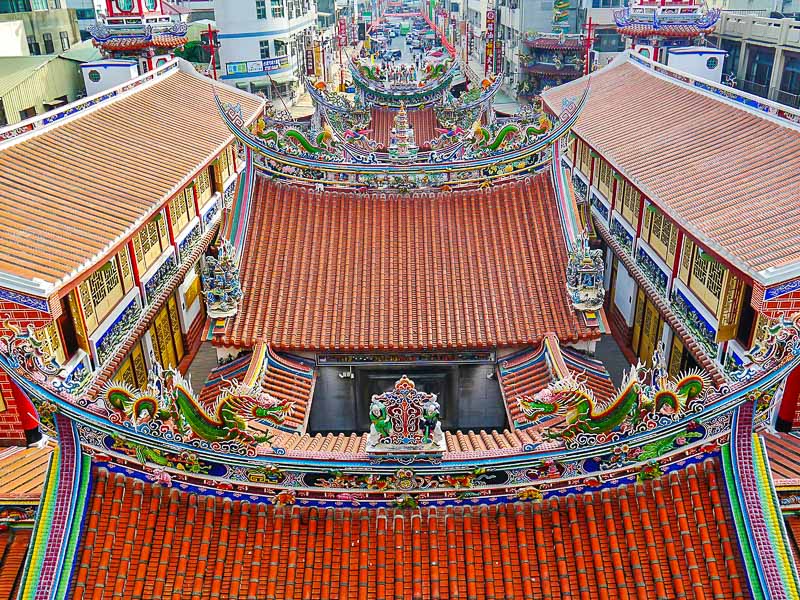 Looking down at the orange tiled roof of Beigang Chaotian Temple, with pavilions on the sides and Old Street leading away from it in the background