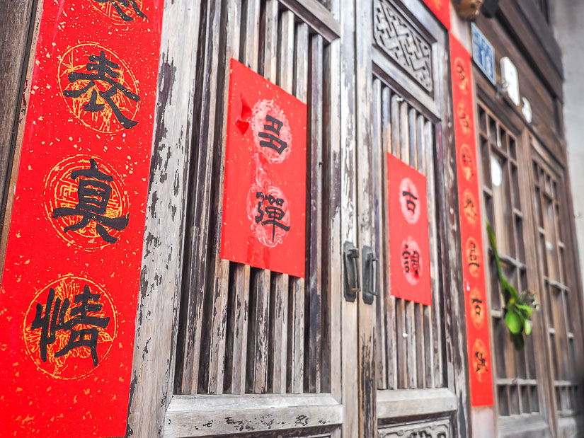 A traditional wooden house front with red Chinese couplets posted on front in Changhua, Taiwan