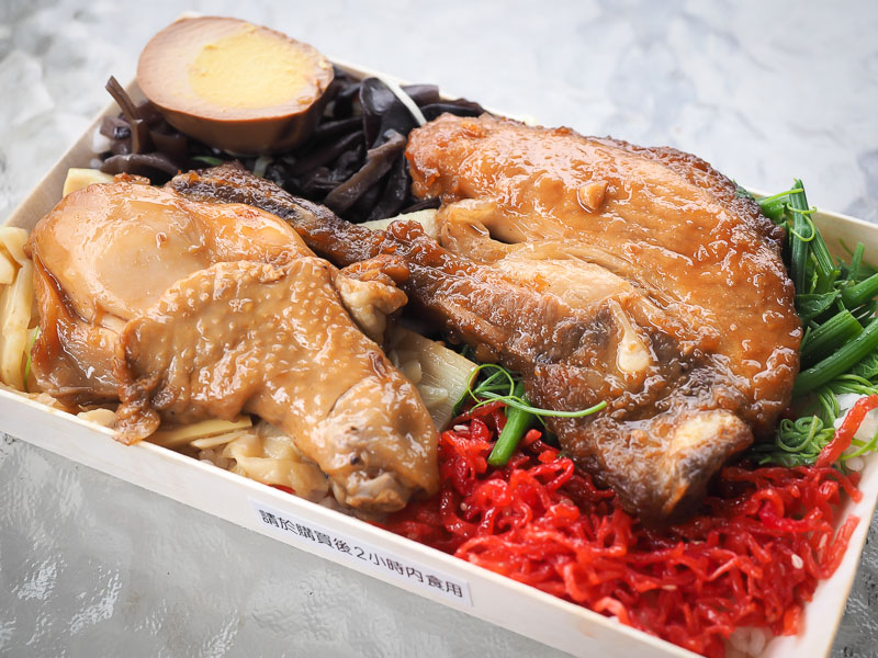 A close up of a Taiwanese lunchbox from Fenqihu, with chicken, egg, tofu, veggies, and more