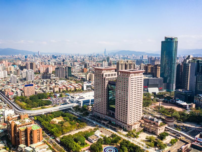 A cityscape, with tall twin towers of Banqiao Station at the center