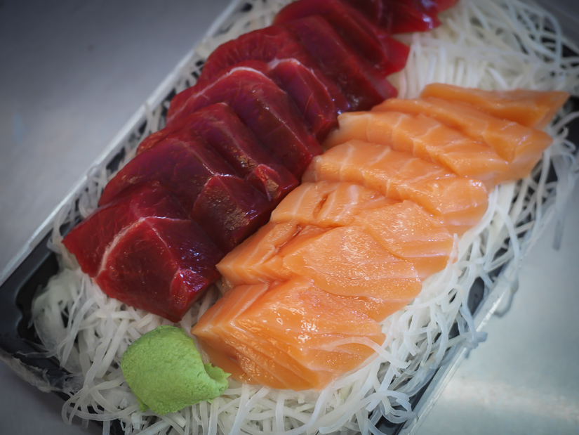 A plate of bluefin tuna and salmon sashimi with wasabi