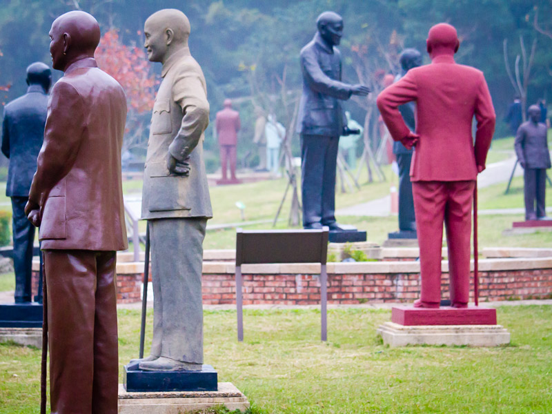 A collection of different colored Chiang Kai-shek statues in a park