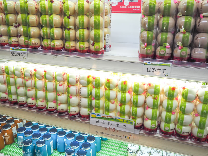 Stacks of yogurt containers for sale in a shop