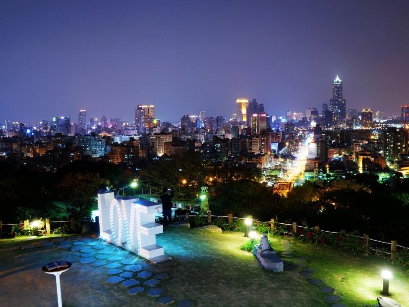 A lit up sign that says LOVE overlooking the city of Kaohsiung
