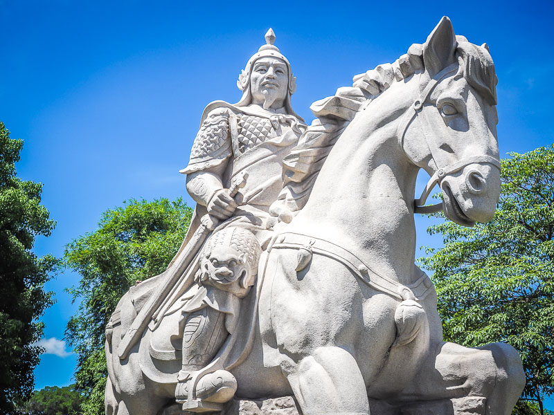 A large white statue of Koxinga riding a horse