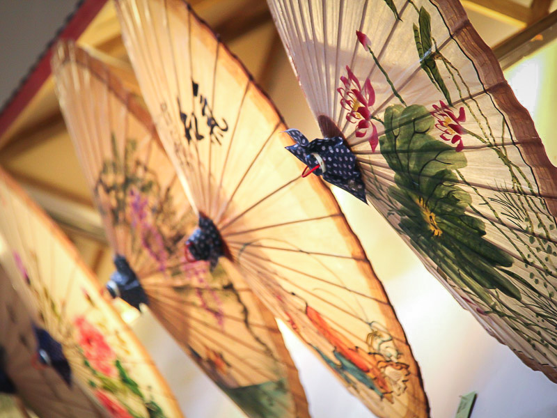 Some painted paper umbrellas on a wall