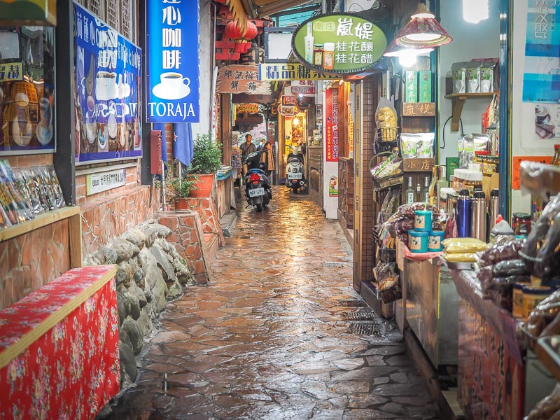A narrow old street in Taiwan with vendors on either side