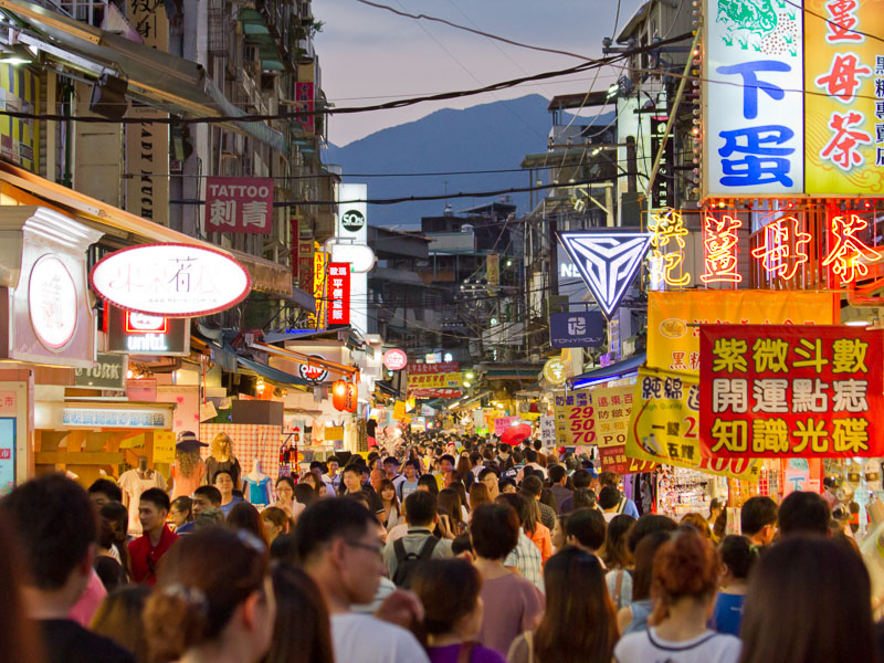 A very crowded lane inside Shilin Night Market at night