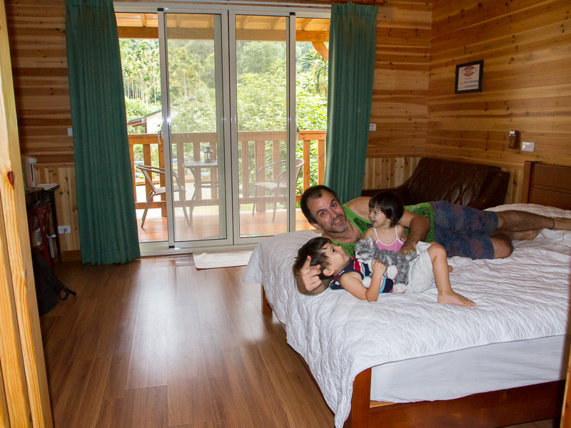 Nick Kembel playing with his two kids inside a wooden cabin at Sun Moon Lake