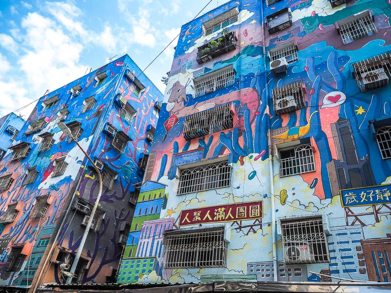 A low rise building covered in street art