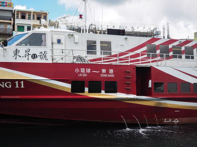 A ferry boat that says Xiaoliuqiu to Donggang on it