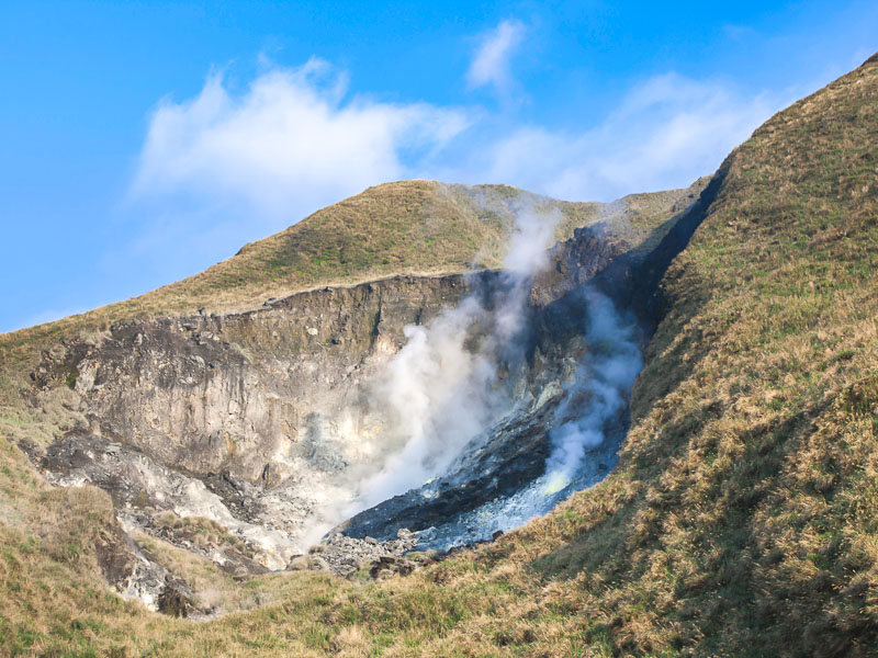 A steaming fumarole on the side of a mountain in Yangmingshan National Park