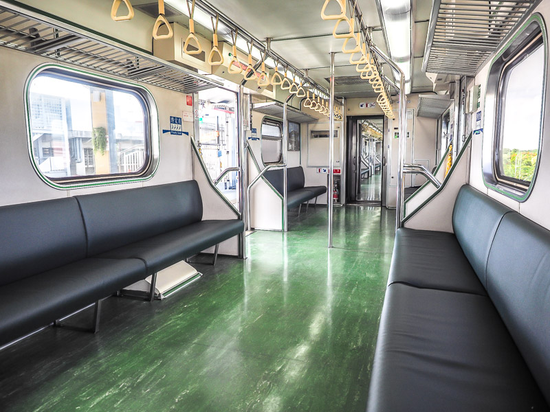 An empty local train with benches on the sides