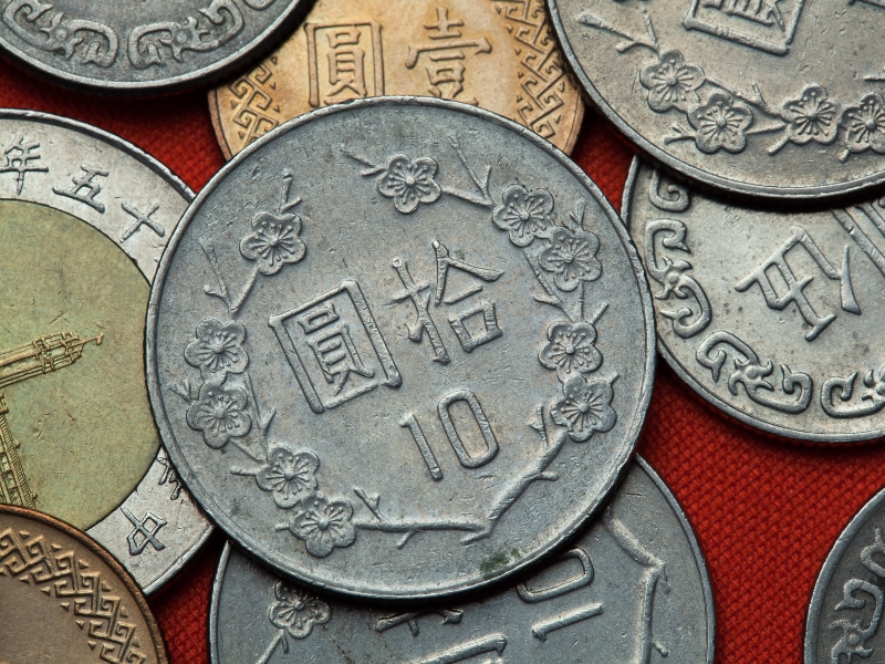 Close up of several Taiwanese coins on a table
