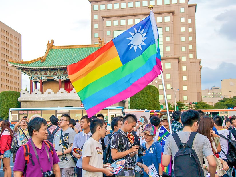 A gay pride Taiwan flag and gathering of people for the Taipei Pride Parade